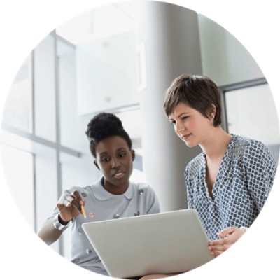 Acuity Revenue Cycle Analytics - two women in discussion looking at laptop