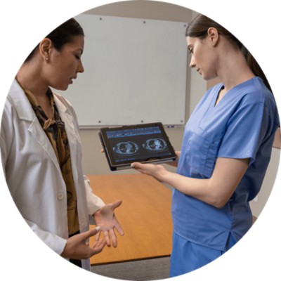 糵 Imaging Fellow - two female providers reviewing imaging results on tablet