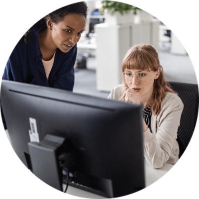 Clinical Abstraction - two businesswomen working at computer