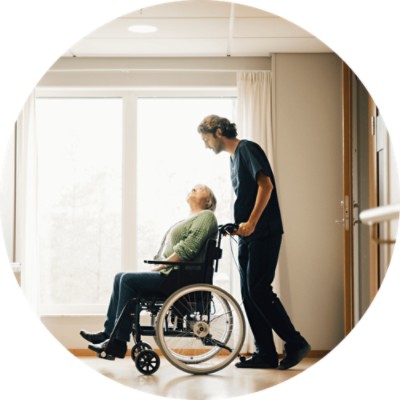 Community Connector - Nurse pushing elderly lady in wheelchair