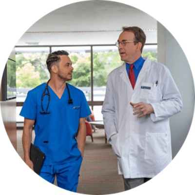 doctors walk and talk down hallway