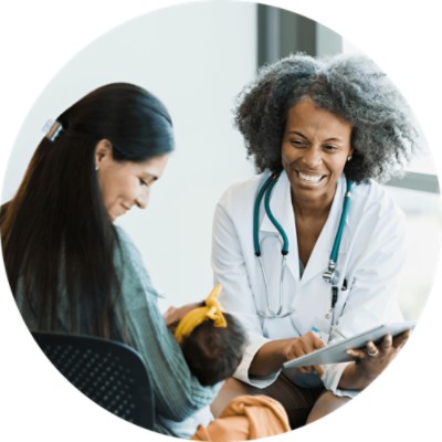 physician and patient smile at baby