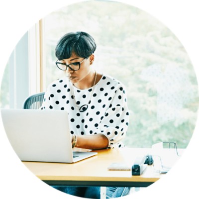 Woman sitting at table and using a laptop