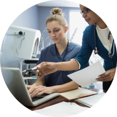 Doctor and nurse discussing something on computer screen