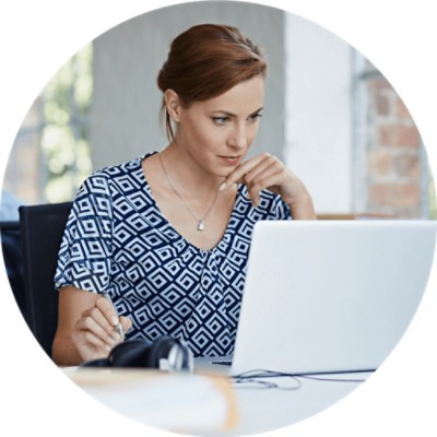 Woman thinking and looking at laptop