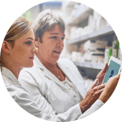 Pharmacy Management Software Solutions - pharmacists looking at tablet