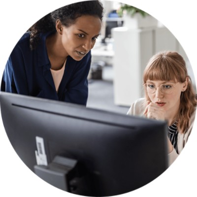 Coding Advisor - two businesswomen working at computer