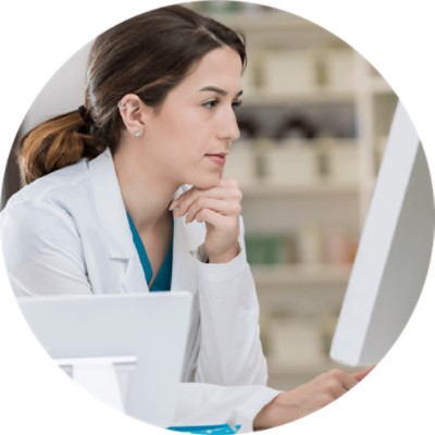 Pharmacy Management Software Solutions - pharmacist looking at computer screen