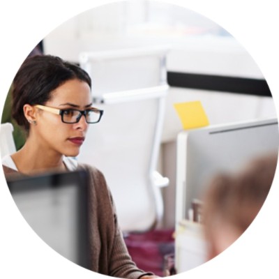 Woman at desk looking at computer screen