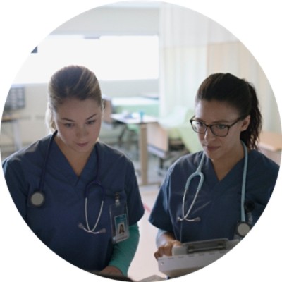 Two nurses looking at something