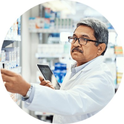 Pharmacist looking at medication on shelf